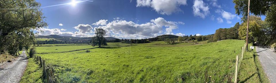 a panorama of the River Tay valley with Aberfeldy visible in the distance