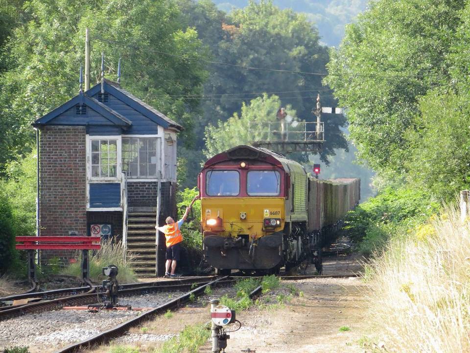 Freight train at Pantyffynnon. The signalman at Pantyffynnon hands the driver of DB class 66 locomotive No. 66187 the token for the Gwaun-cae-Gurwen freight-only branch.