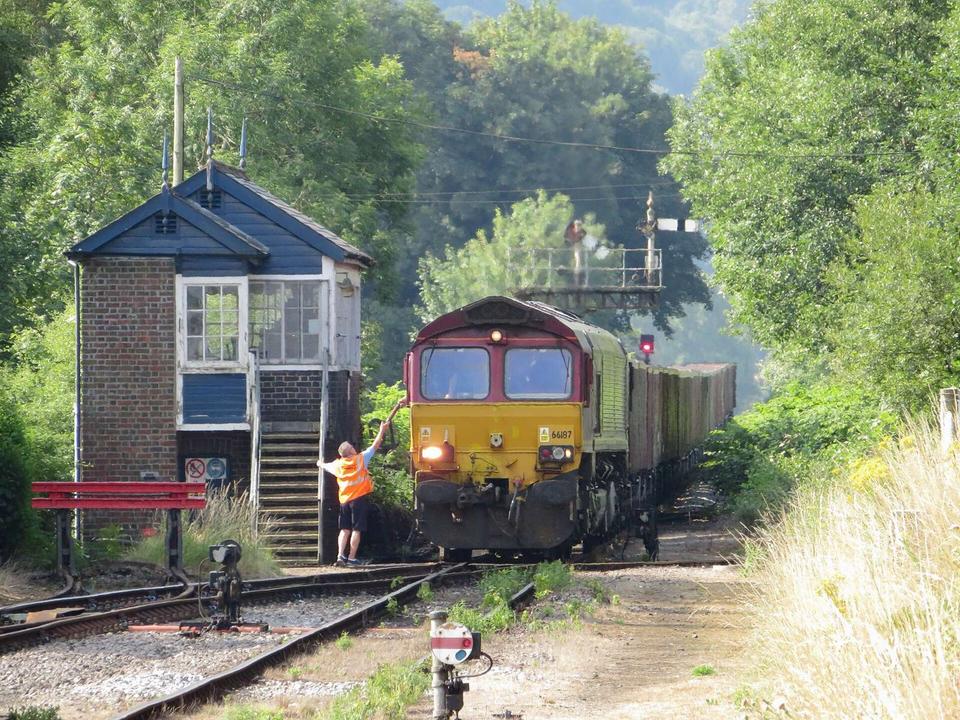 Freight train at Pantyffynnon. The signalman at Pantyffynnon hands the driver of DB class 66 locomotive No. 66187 the token for the Gwaun-cae-Gurwen freight-only branch.