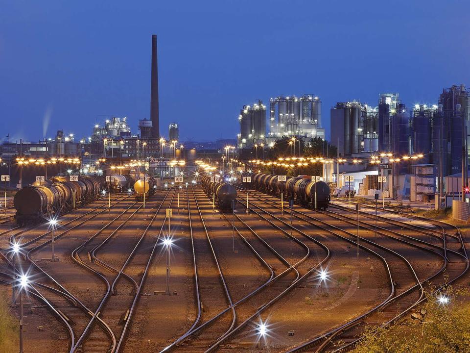 Classification yard Godorf, Cologne, at dusk with LyondellBasell Industries refinery in the background.