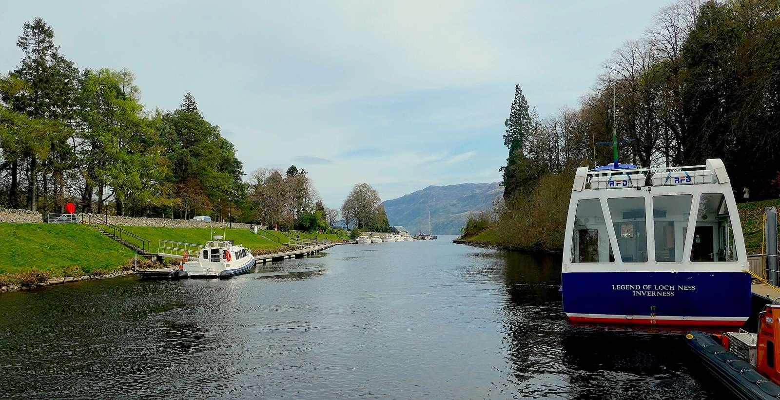 Fort Augustus and Loch Ness. The 'Legend of Loch Ness' awaits its next 'load' of passengers for a cruise on the western end of Loch Ness. This is the cut between the lock flight and Loch Ness. The lan