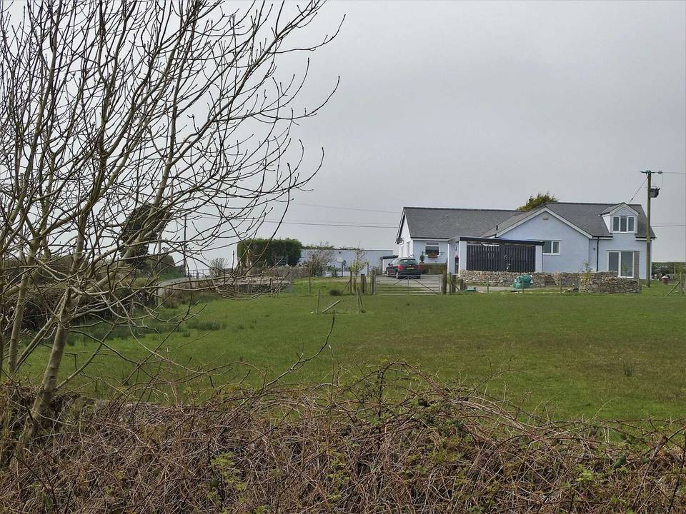 Bungalow by a road junction north of Llanerchymedd