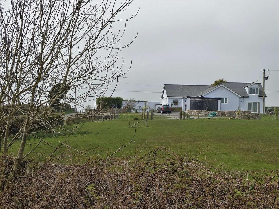 Bungalow by a road junction north of Llanerchymedd