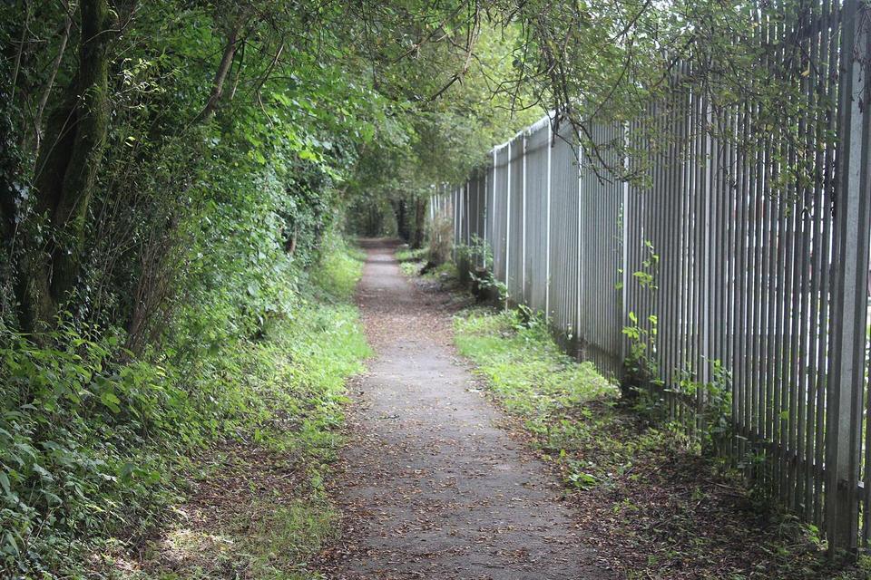 Path to town centre by metal fence