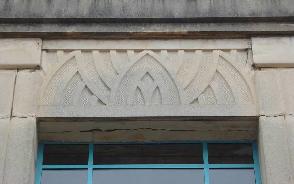 Stonework detail on the exterior of Burton's art deco shop, Abergavenny.