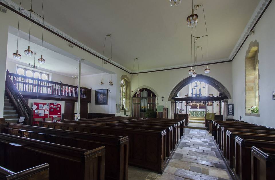 The church dates from around 1200 and consists of a western tower, nave, chancel, north transept and vestry. The tower dates from the late 16th century and has an embattled parapet with pinnacles and 