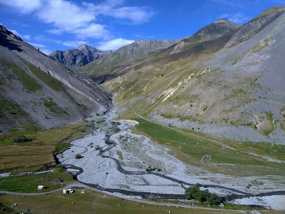 Sight of Combe de Mortavieille valley and Lauzette river (ahead) flowing into Valloirette river, between Valloire and col du Galibier pass, in Savoie, France.