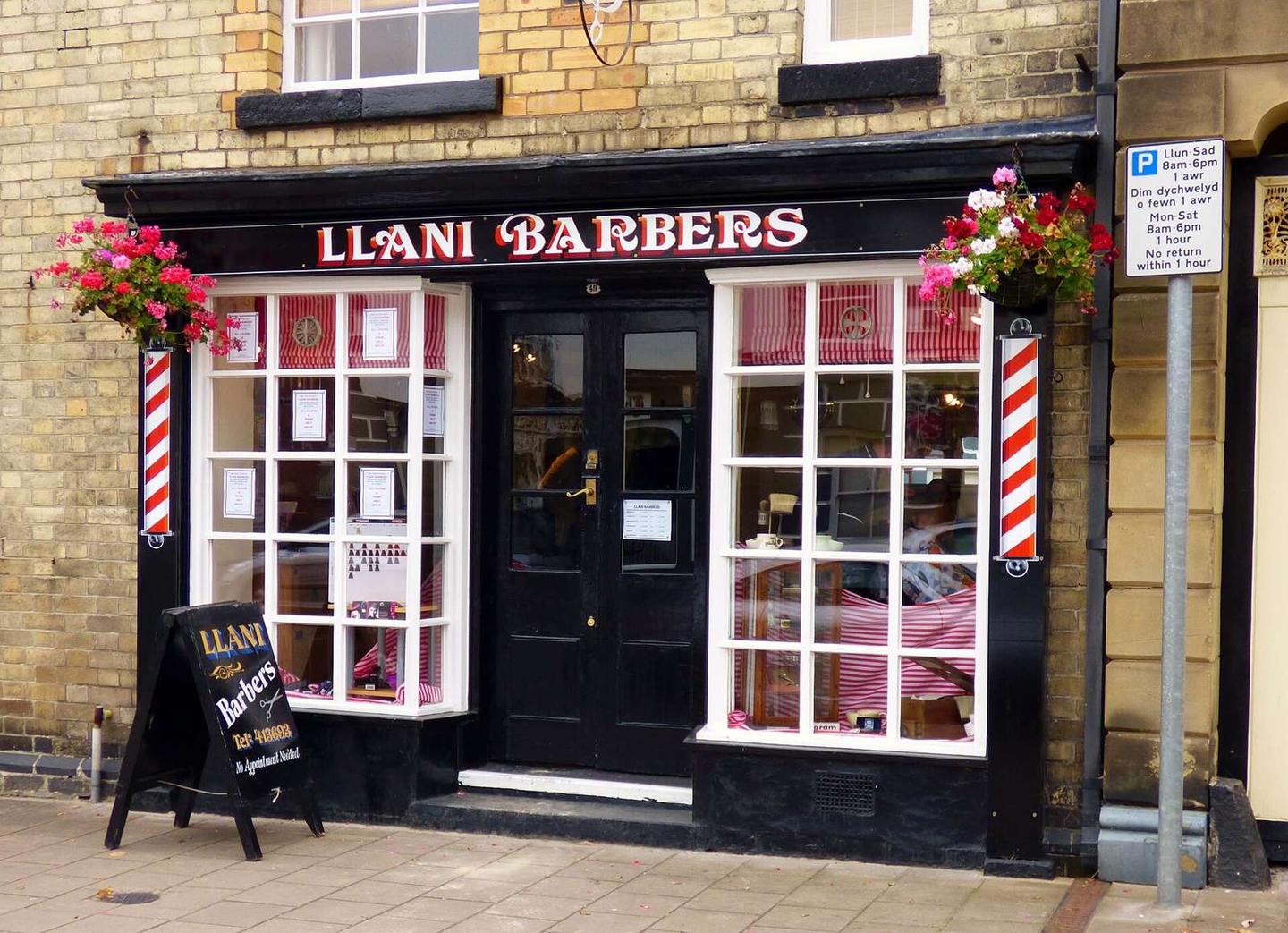 A barber with the traditional red and white striped symbols.